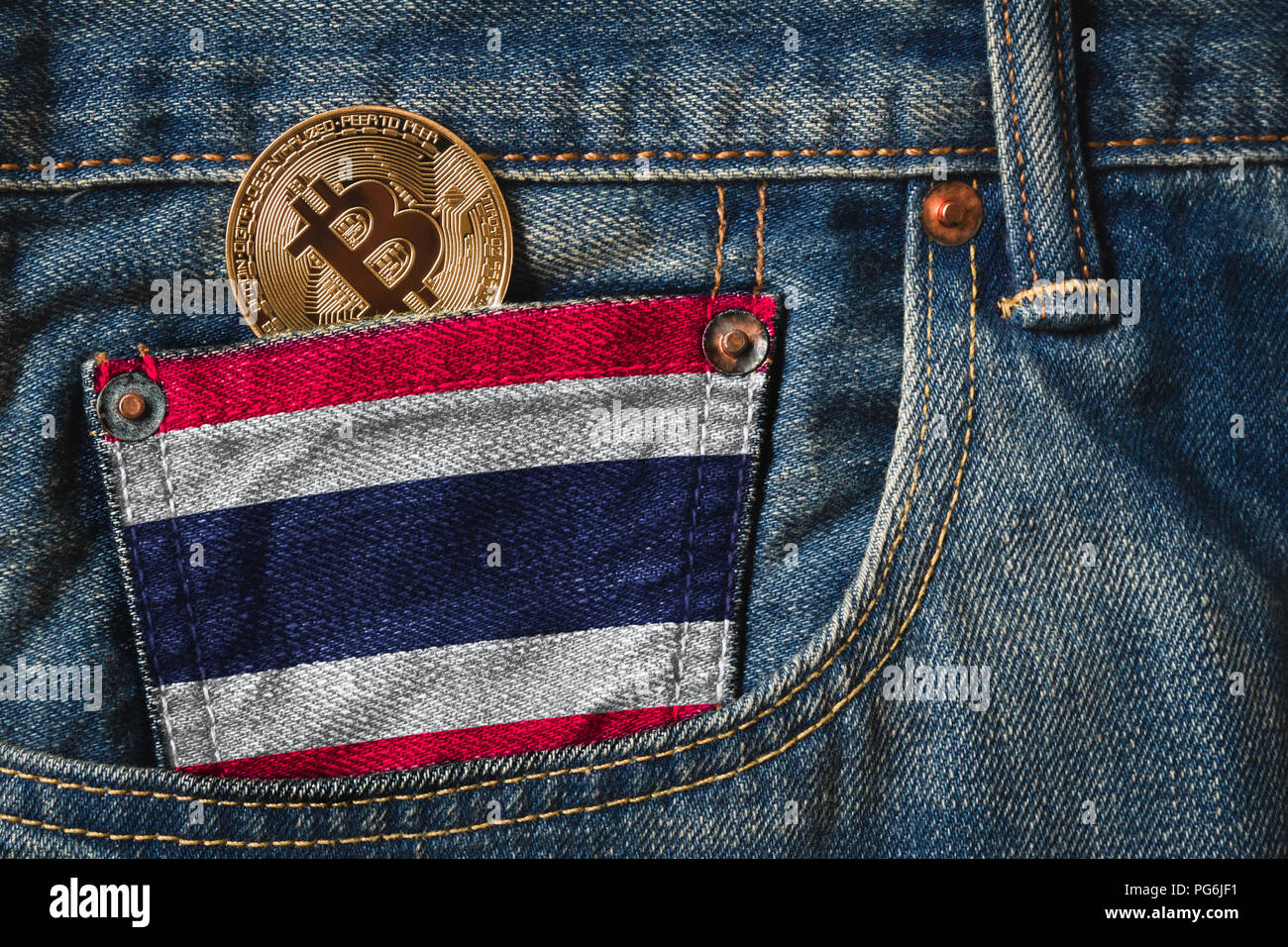 Golden BITCOIN (BTC) cryptocurrency in the pocket of jeans with the flag of  Thailand on Jeans Denim Texture Stock Photo - Alamy
