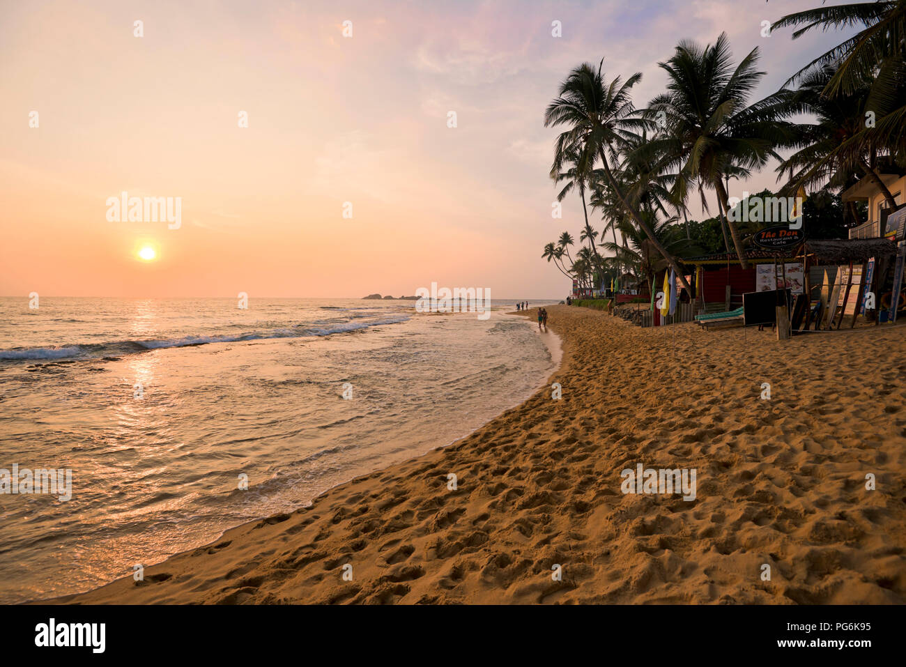 Horizontal view of the beach at sunset in Hikkaduwa, Sri Lanka. Stock Photo