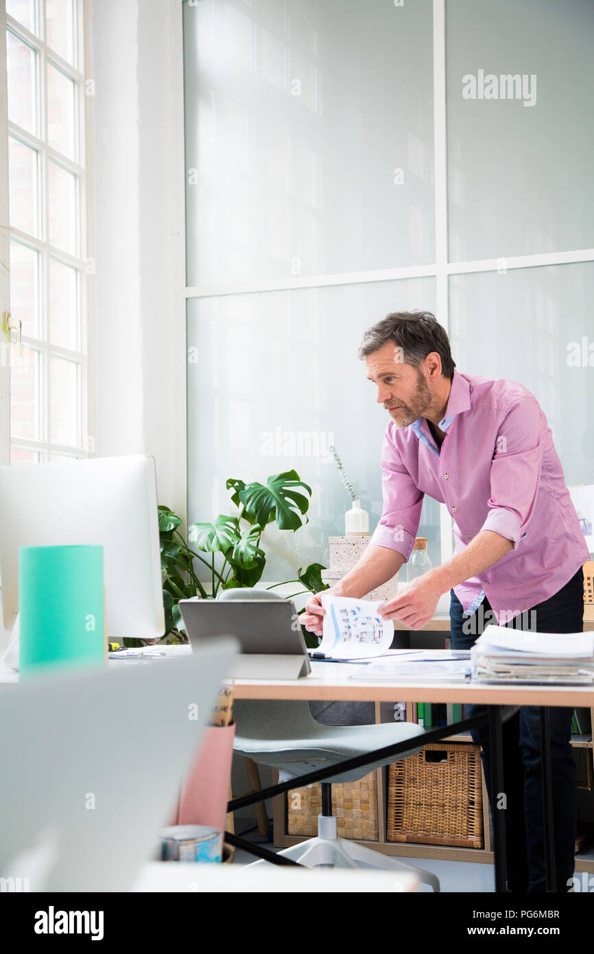 Man working at desk in office Stock Photo