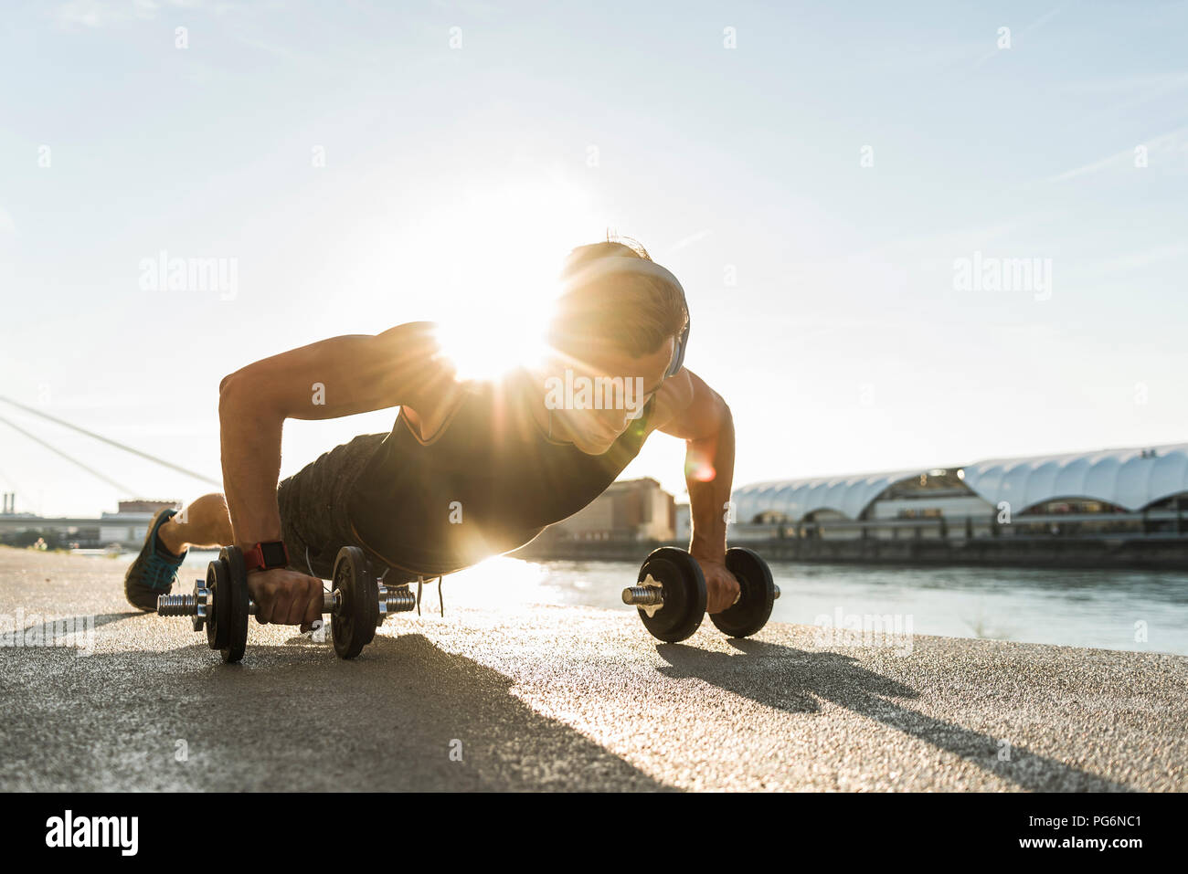 Fit athlete doing push ups at the river Stock Photo - Alamy