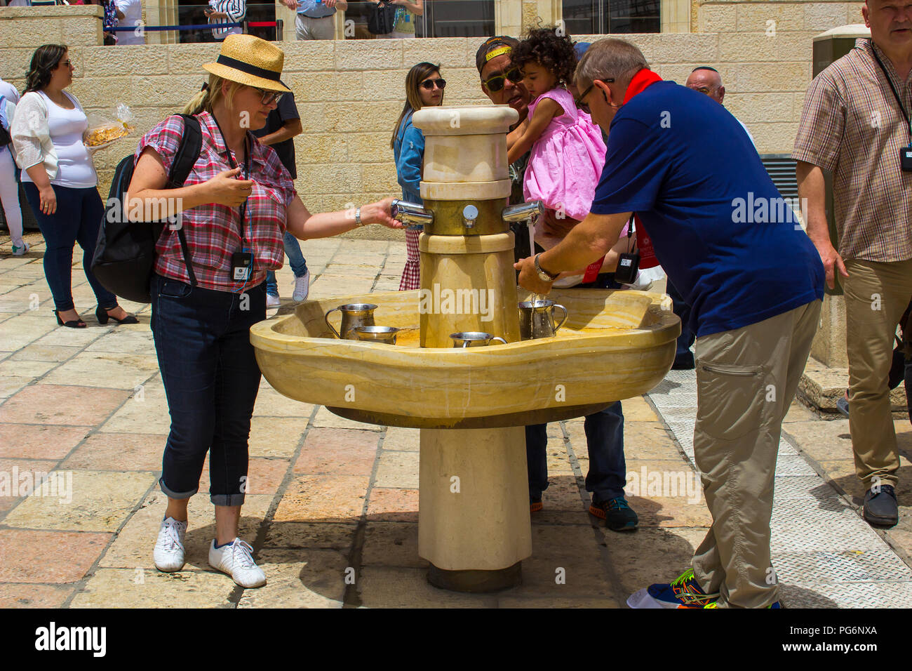 10 May 2018 Jewish pilgrims washing and drinking at a water faucet