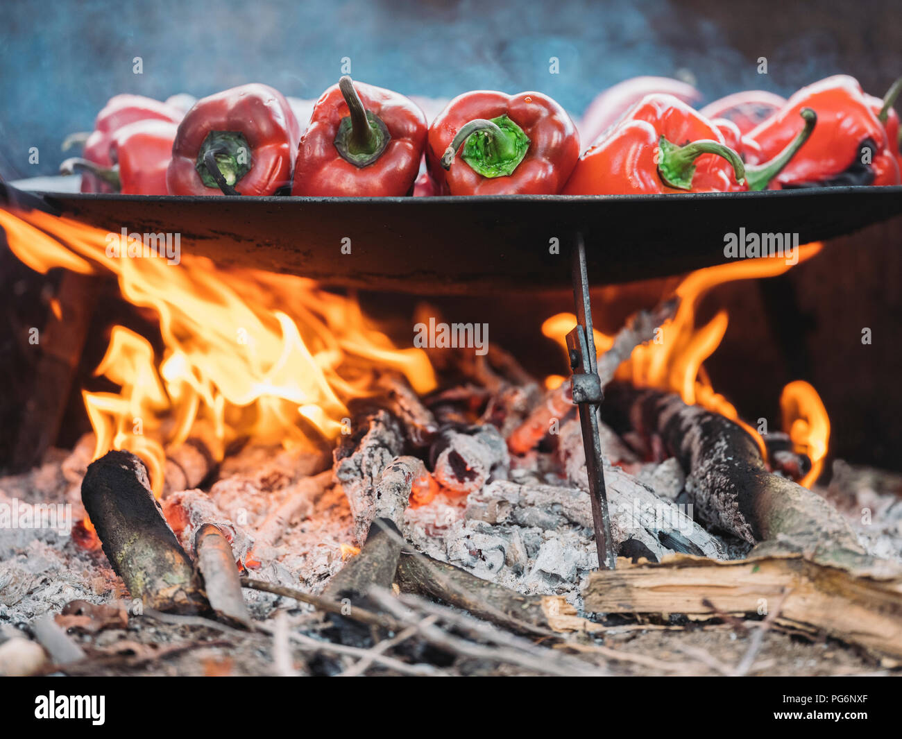 Red bell peppers on barbecue tray, fire Stock Photo Alamy