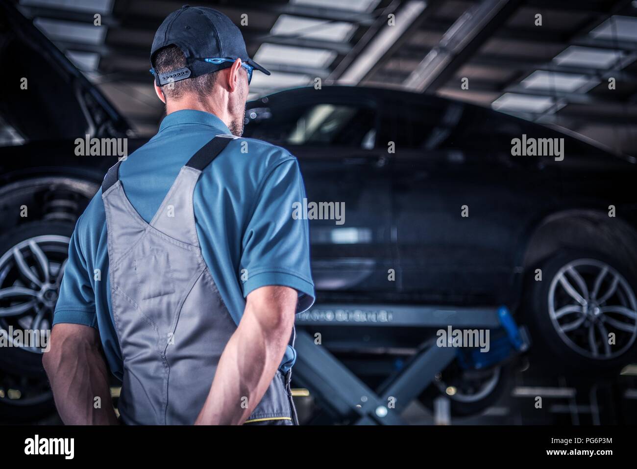 Caucasian Auto Service Mechanics Supervisor on Duty. Stock Photo