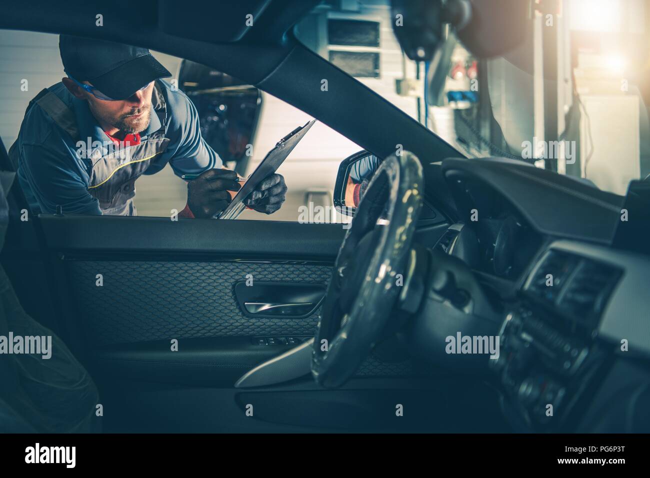 Auto Service Worker Inspection. Checking For Milage and On Board Computer Error Codes. Stock Photo