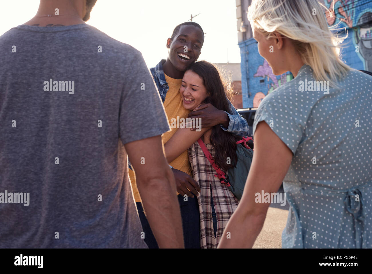 Two happy young couples outdoors on the go Stock Photo