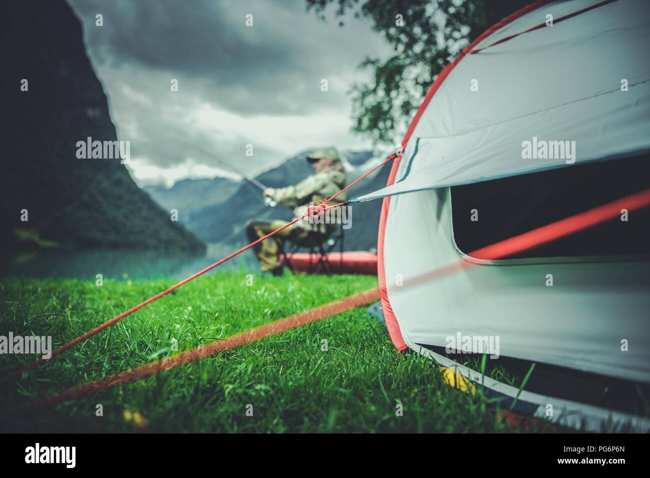 Fly Fishing Camping Time. Fisherman and His Tent on a Campsite. Stock Photo