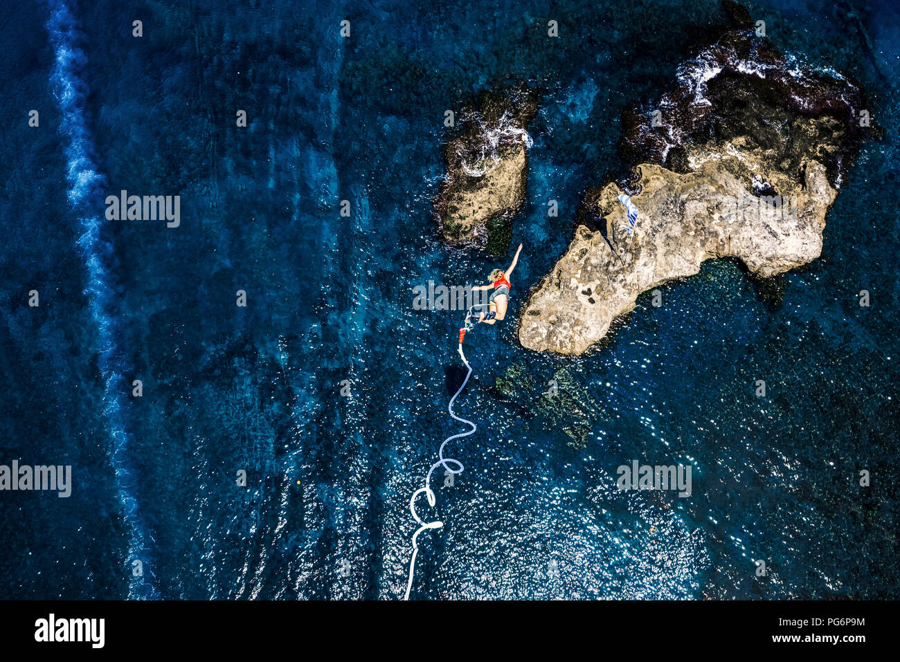 Greece, Crete, Bungee Jumping, woman jumping bungee over sea Stock