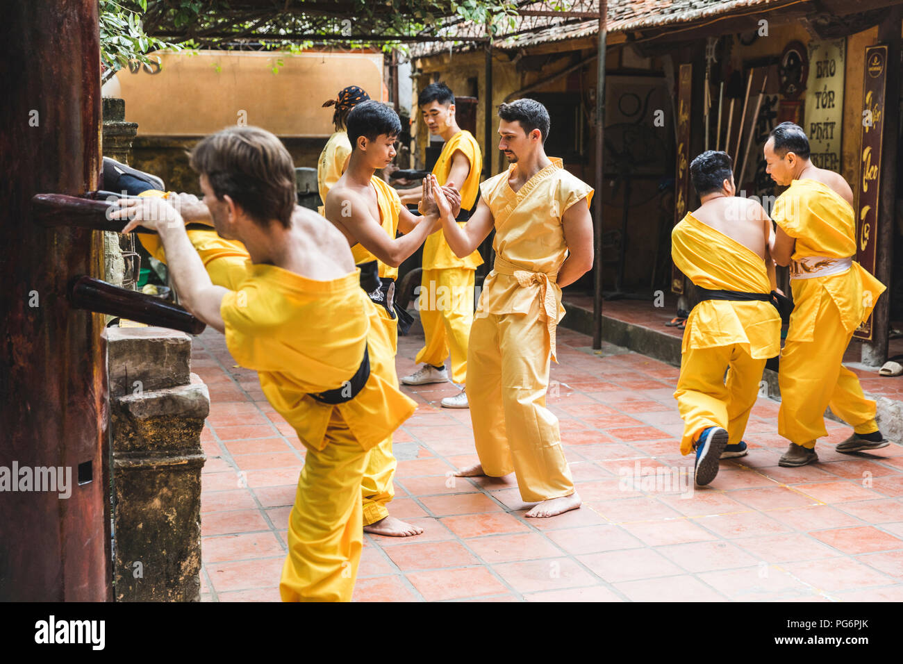 Vietnam, Hanoi, men exercising kung fu, european man learning kung fu