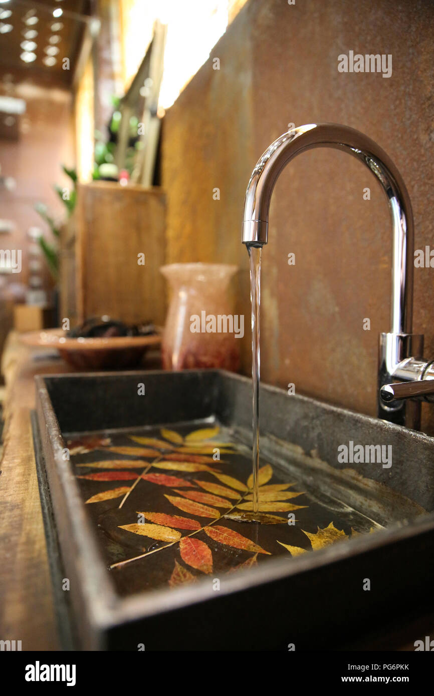 Bathroom sink and stainless steel tap in bathroom with Corten steel