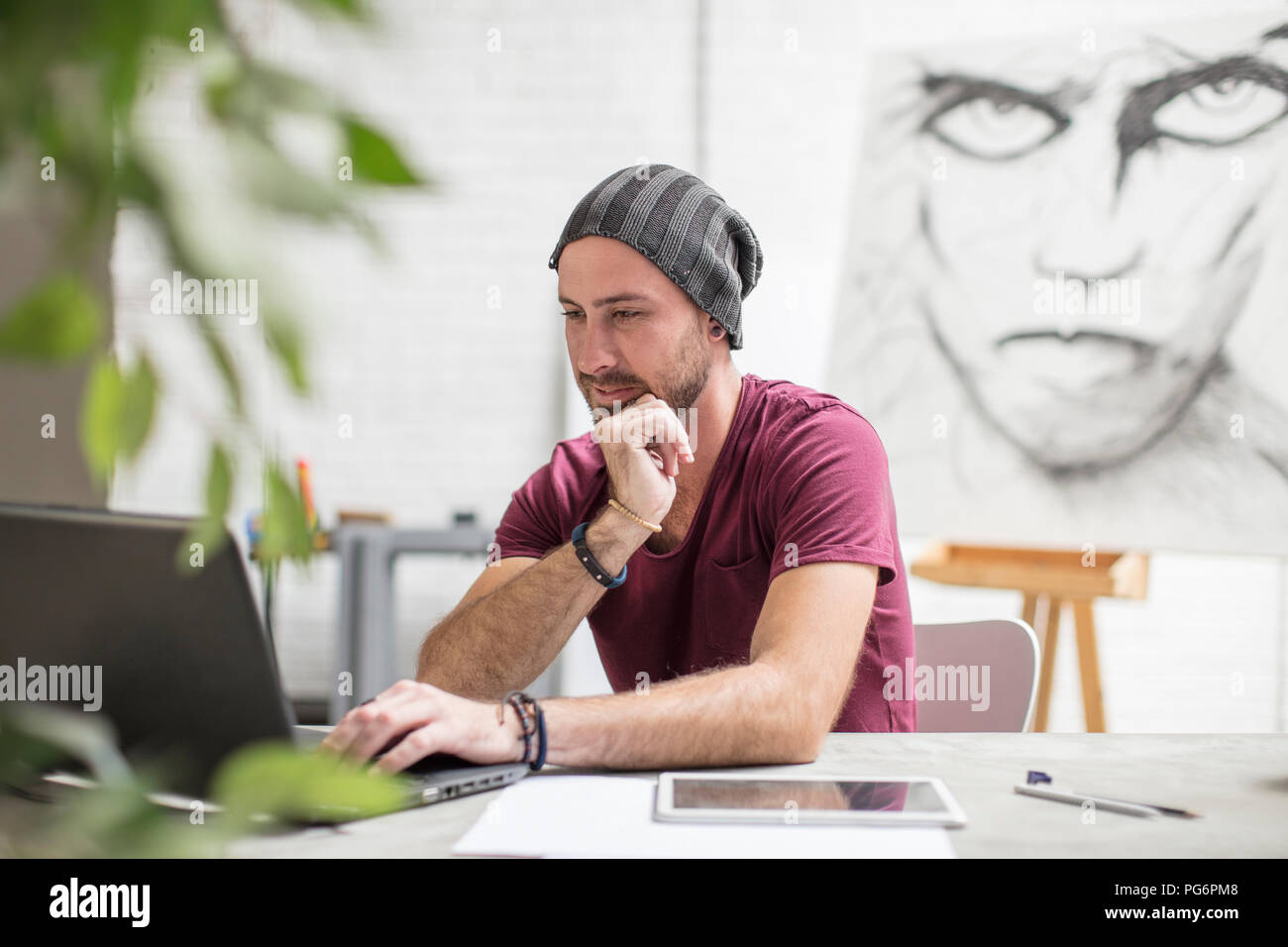 Artist using laptop in studio Stock Photo