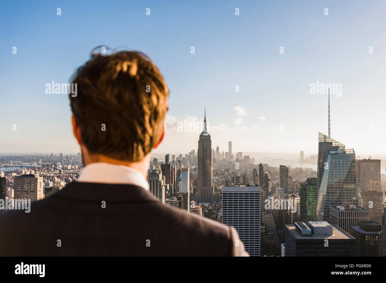 USA, New York City, man looking on cityscape on Rockefeller Center