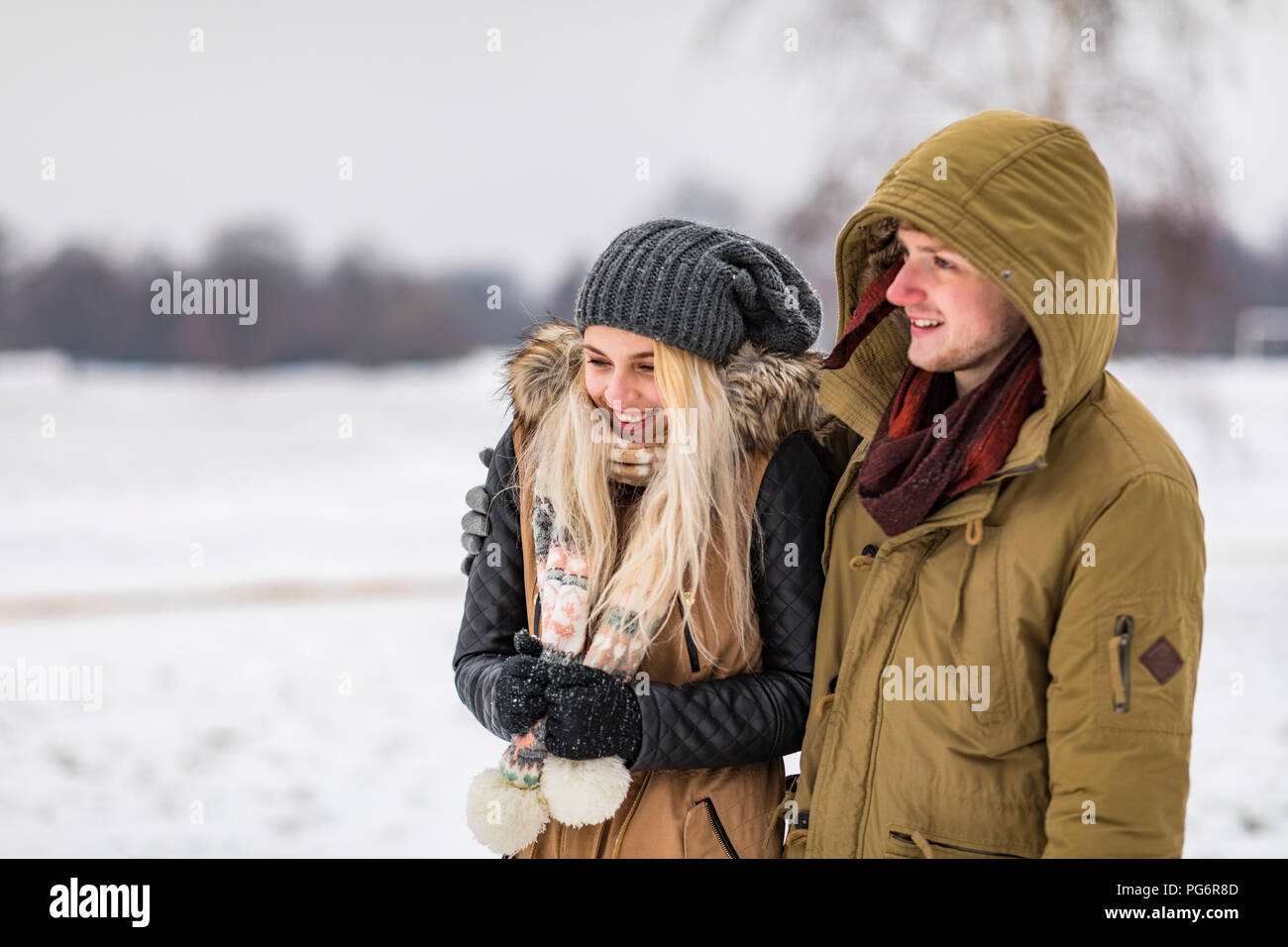 Happy young couple in park on a snowy day Stock Photo