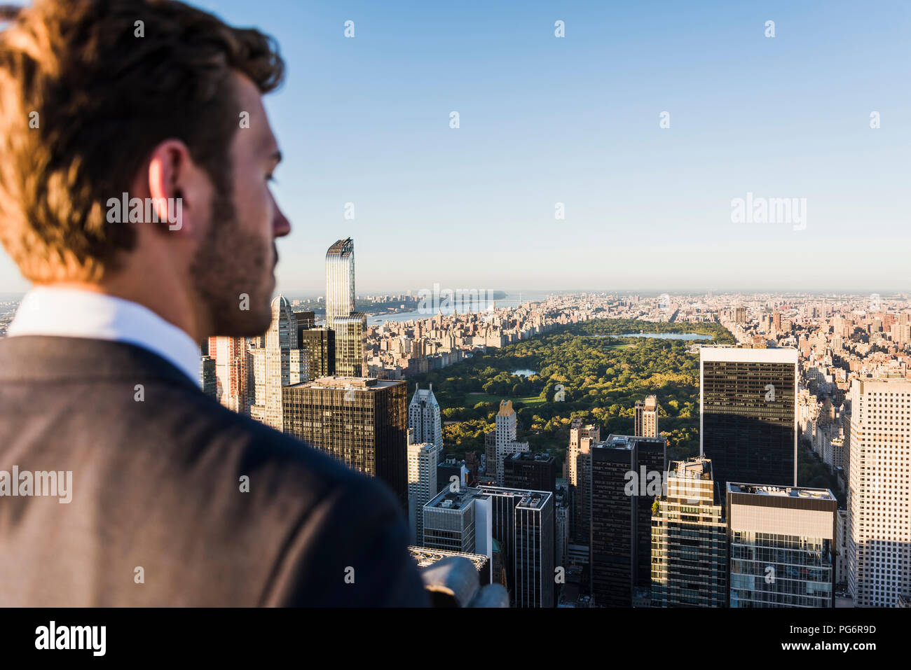 USA, New York City, man looking on cityscape on Rockefeller Center