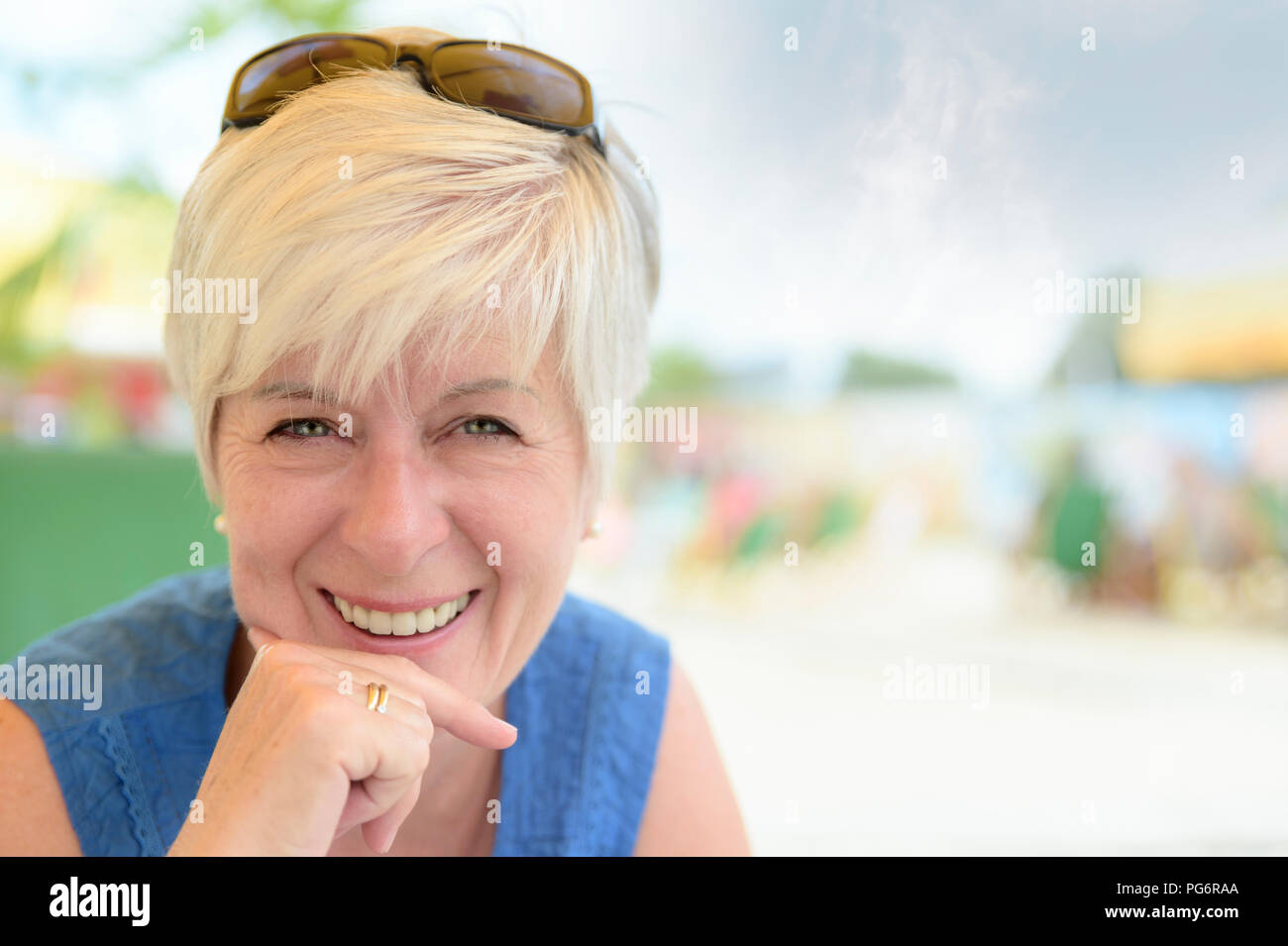 Portrait of smiling senior woman at beach bar Stock Photo