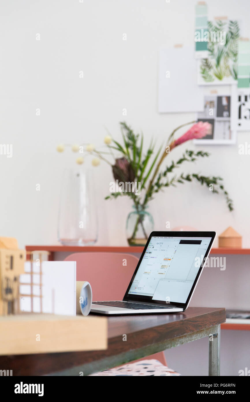Laptop on table in an architect's loft office Stock Photo