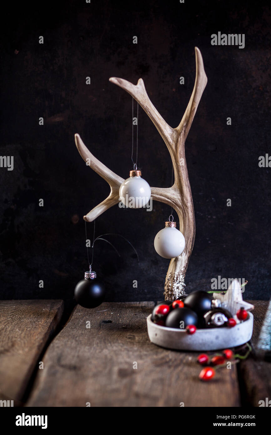 Christmas decoration with antler and  white and black baubles Stock Photo
