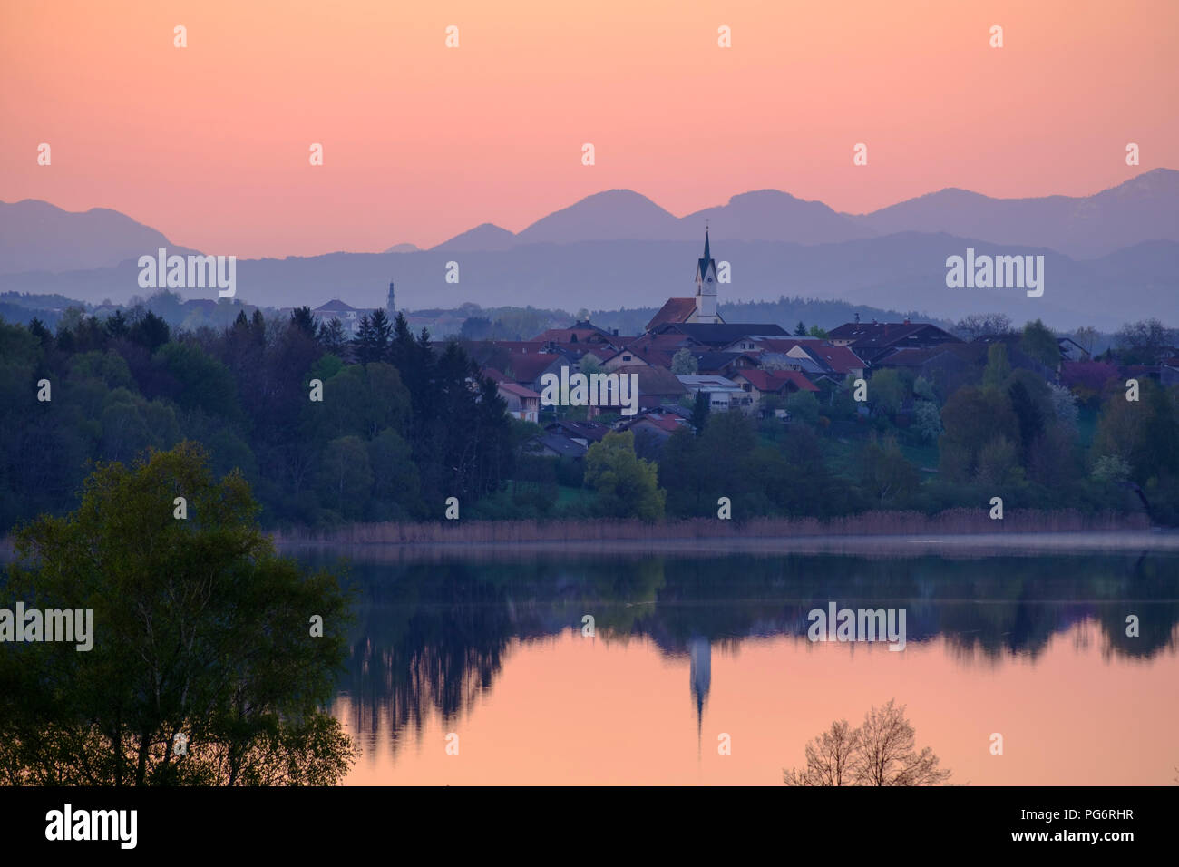 Germany, Bavaria, Upper Bavaria, Chiemgau, Tettenhausen at Tachinger See, Chiemgau and Berchtesgaden Alps in the background, red sky in the morning Stock Photo