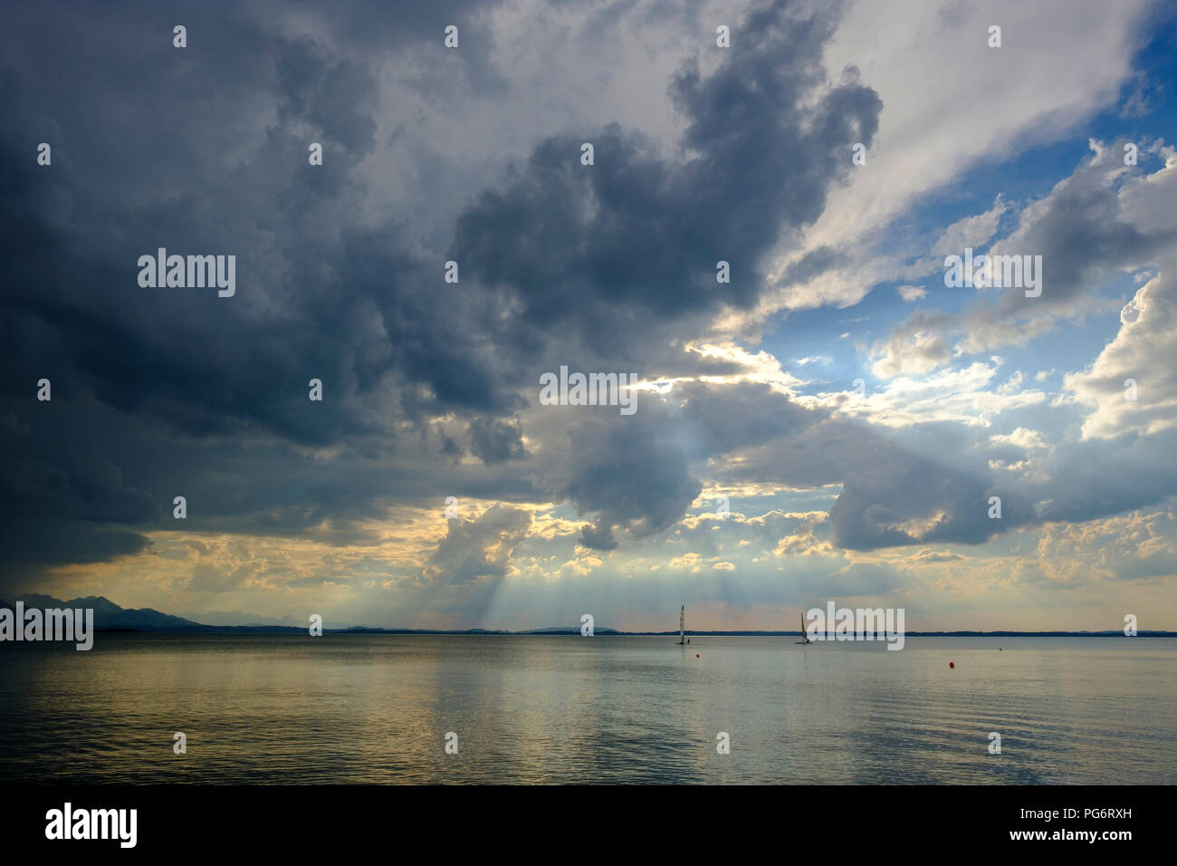 Germany, Bavaria, Chiemgau Alps, Chieming at Chiemsee, dark clouds over Lake Chiemsee Stock Photo
