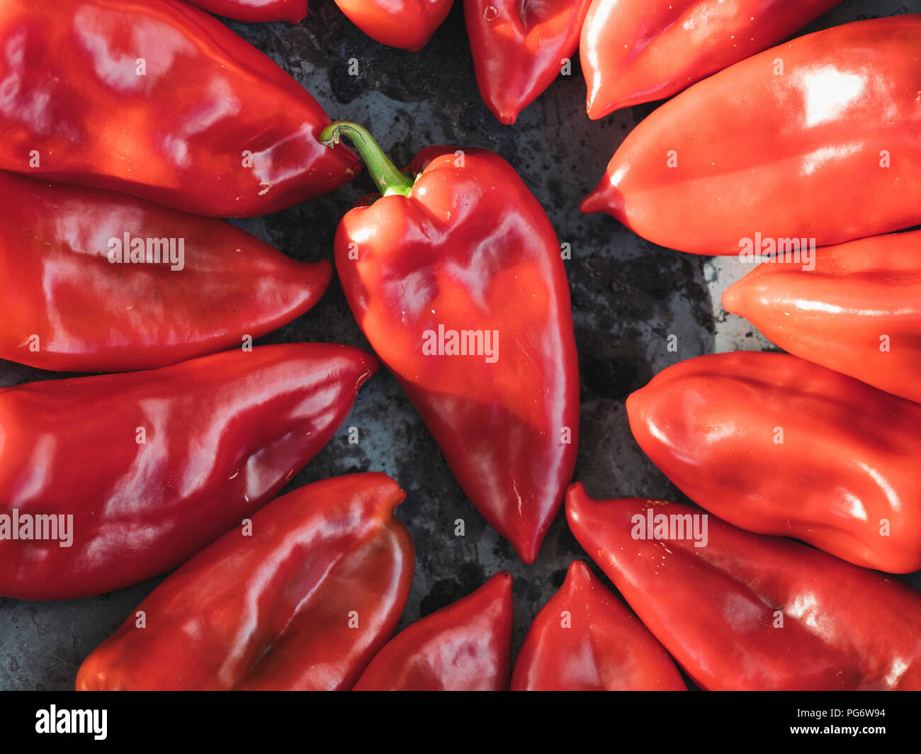 Fresh red bell peppers arranged on a baking tray Stock Photo