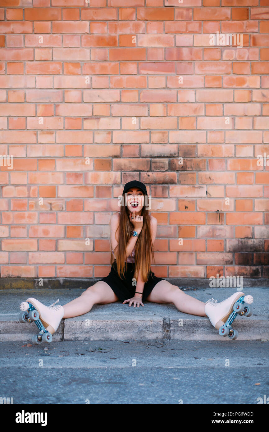 Young woman sitting on curb hi-res stock photography and images - Alamy