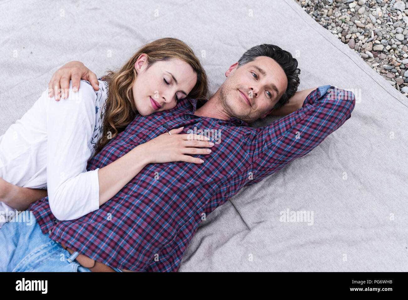 Affectionate couple lying on a blanket Stock Photo Alamy