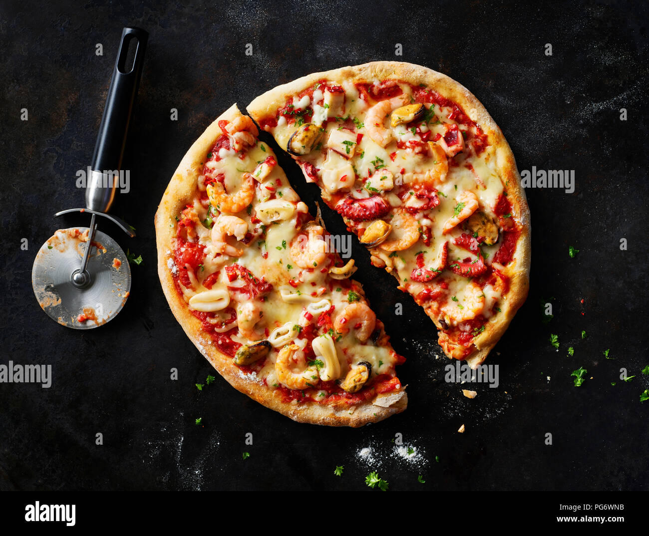 Sliced pizza with frutti di mare on dark ground Stock Photo