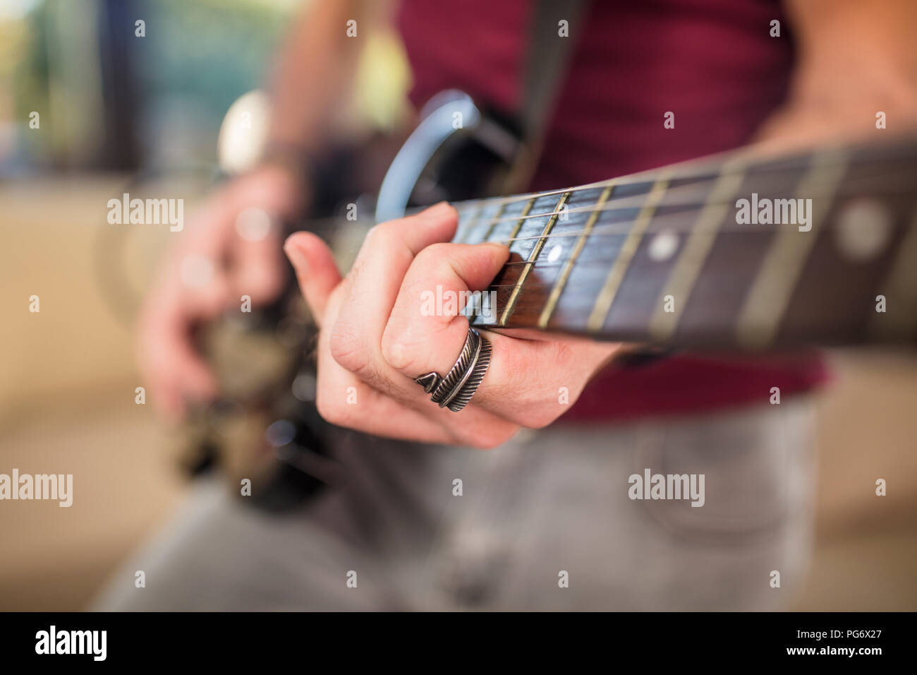Close-up of man's hand playing electric guitar Stock Photo