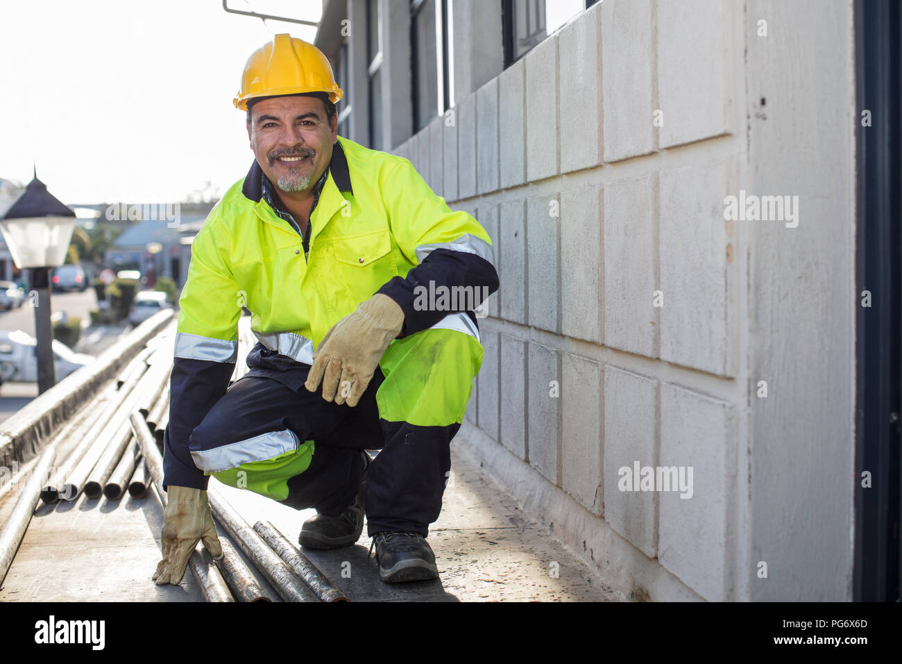 South Africa, Cape Town, Builder with pipes Stock Photo Alamy