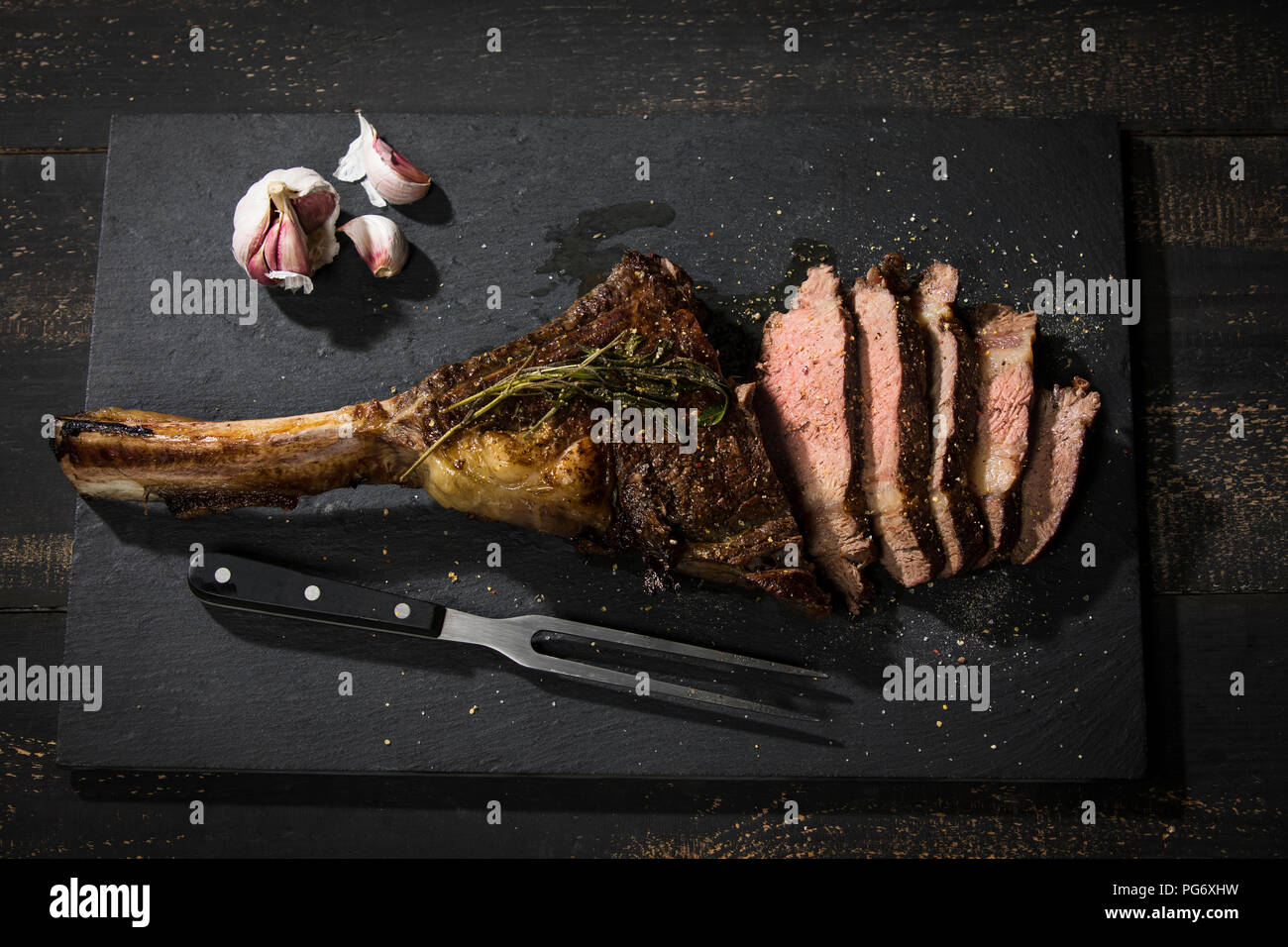 Grilled tomahawk steak and garlic Stock Photo