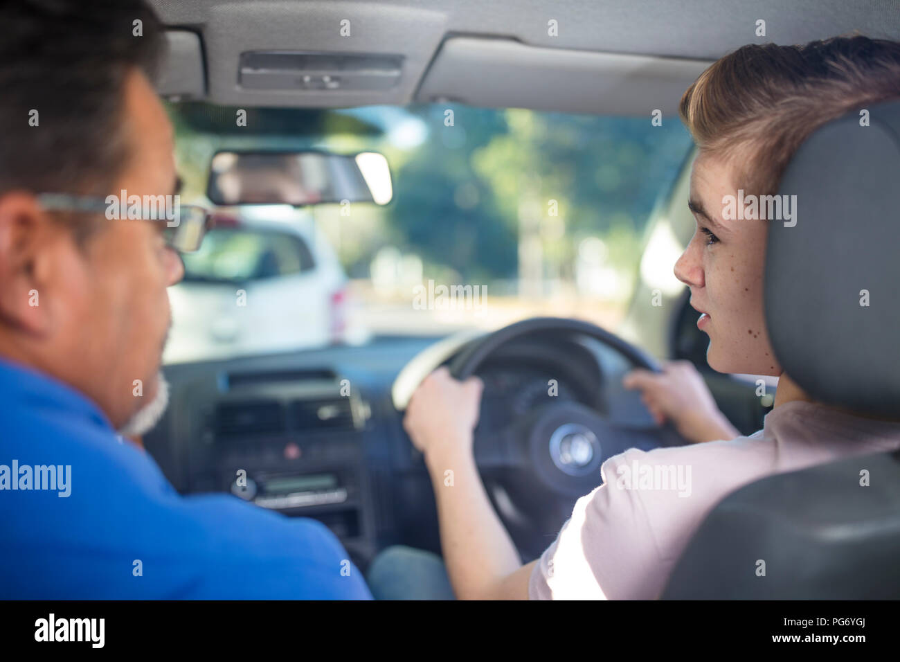 Learner driver with instructor in car Stock Photo Alamy