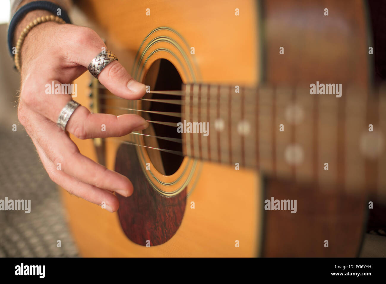 Close-up of man's hand playing guitar Stock Photo