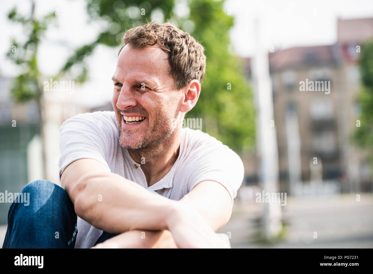 Laughing man sitting hi-res stock photography and images - Alamy