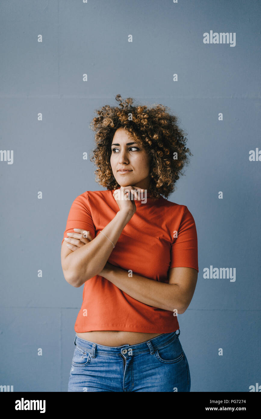 Portrait of a pensive woman with hand on chin Stock Photo