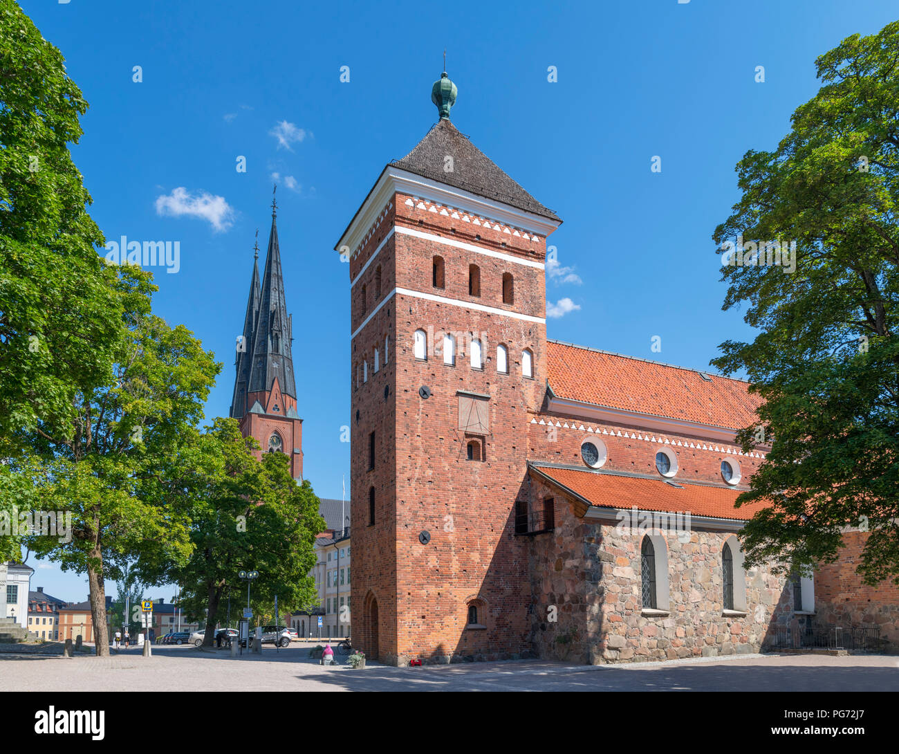 Helga Trefaldighets kyrka (Trinity Church) with the spire of Uppsala Cathedral (Uppsala domkyrka) behind, Uppsala, Uppland, Sweden Stock Photo