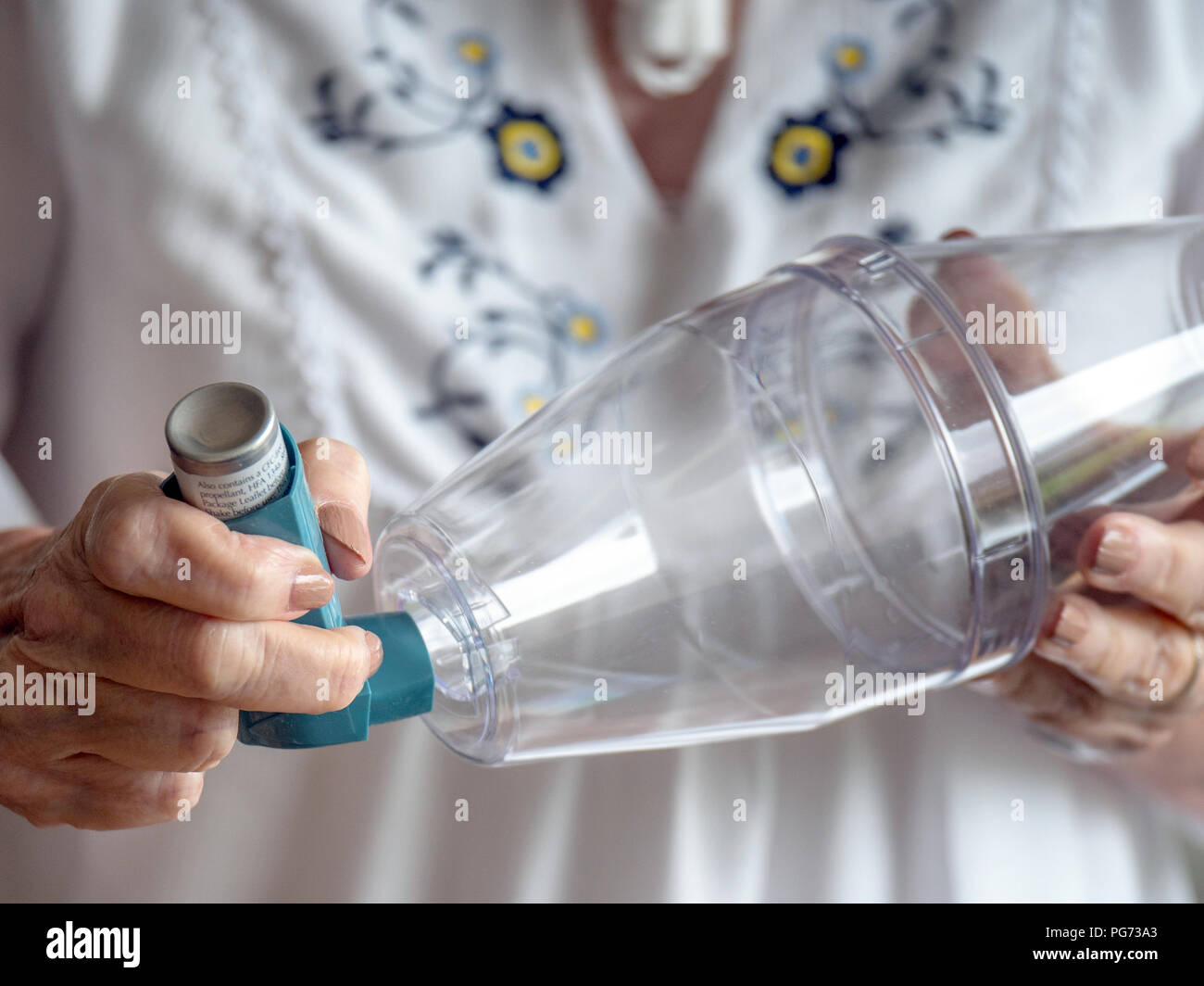 Fitting an asthma inhaler onto a spacer device Stock Photo