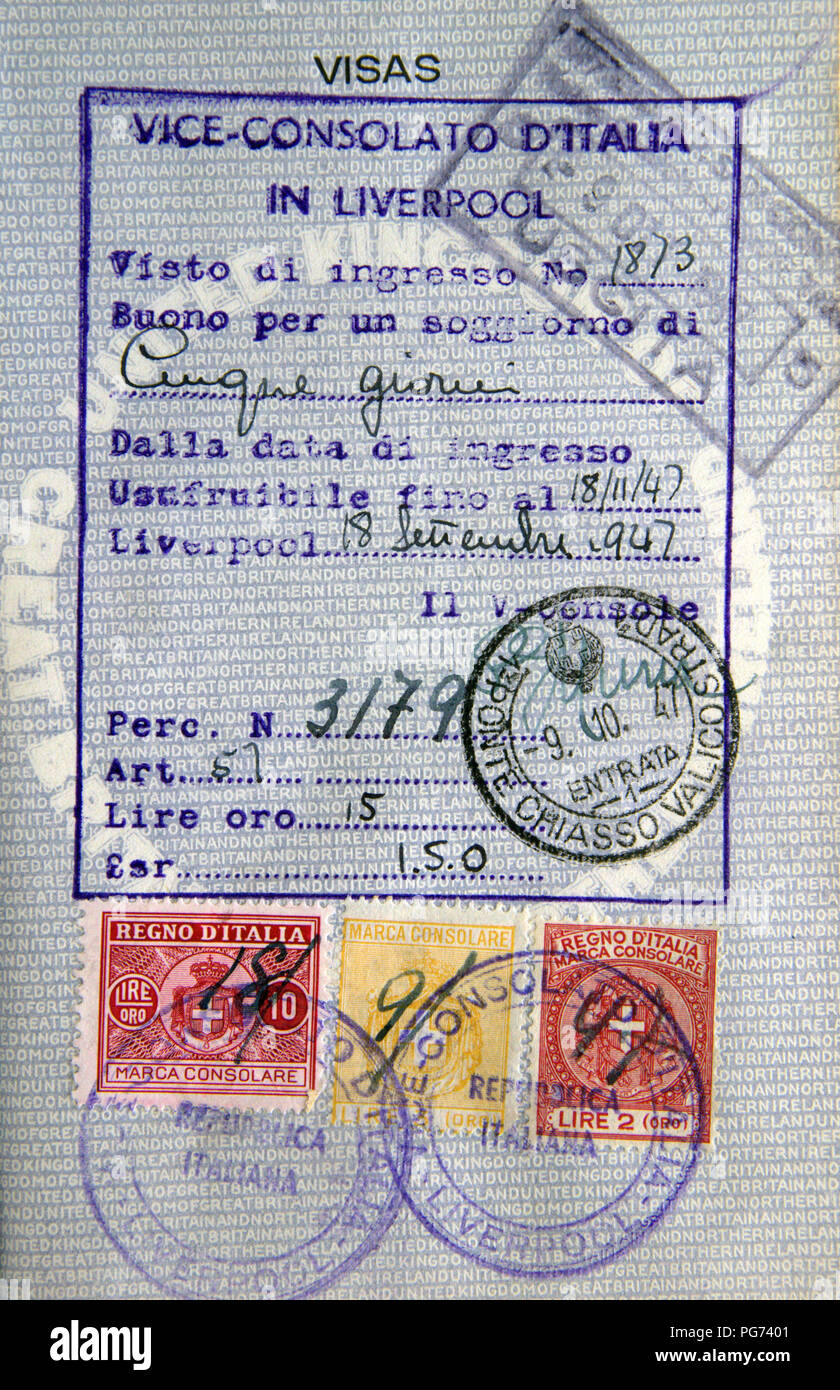 Old British blue passport page with entry visa stamps and an entry permission from the Italian Consulate in Liverpool. Stock Photo