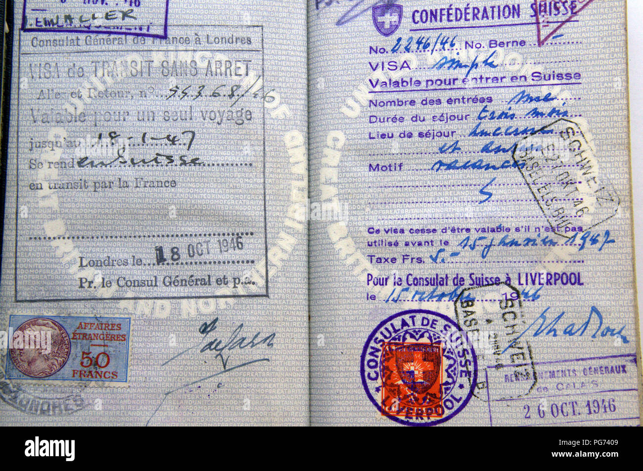 Pages in 1940's vintage British blue passport with entry visa stamps Stock Photo