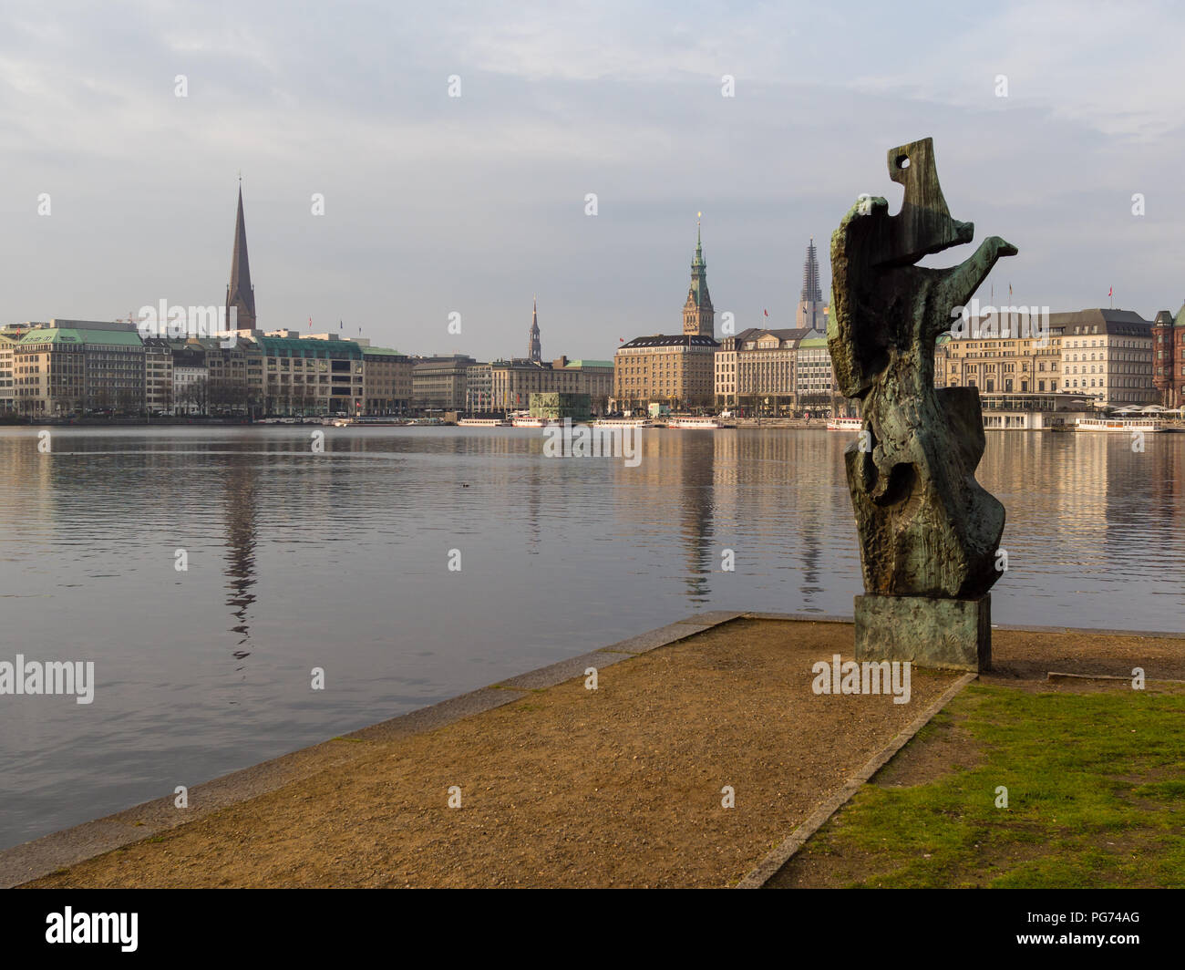 Hamburg, Germany - April 14, 2016: View at sculpture named 'Windsbraut', whirlwind, Inner Alster Lake and Ballindamm, Jungfernstieg and tower of Town  Stock Photo