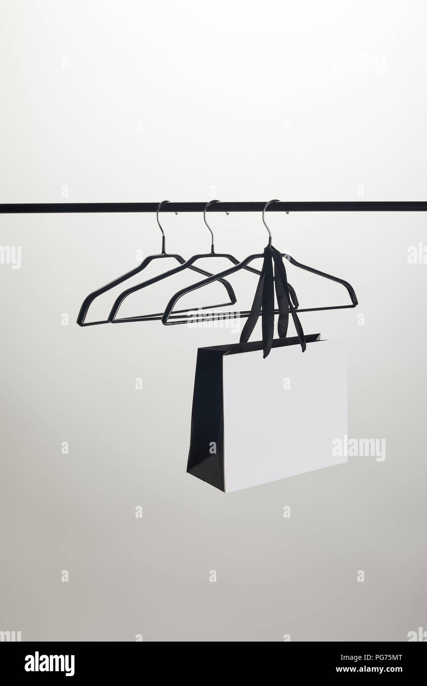 shopping bag and empty hangers on stand isolated on white Stock Photo