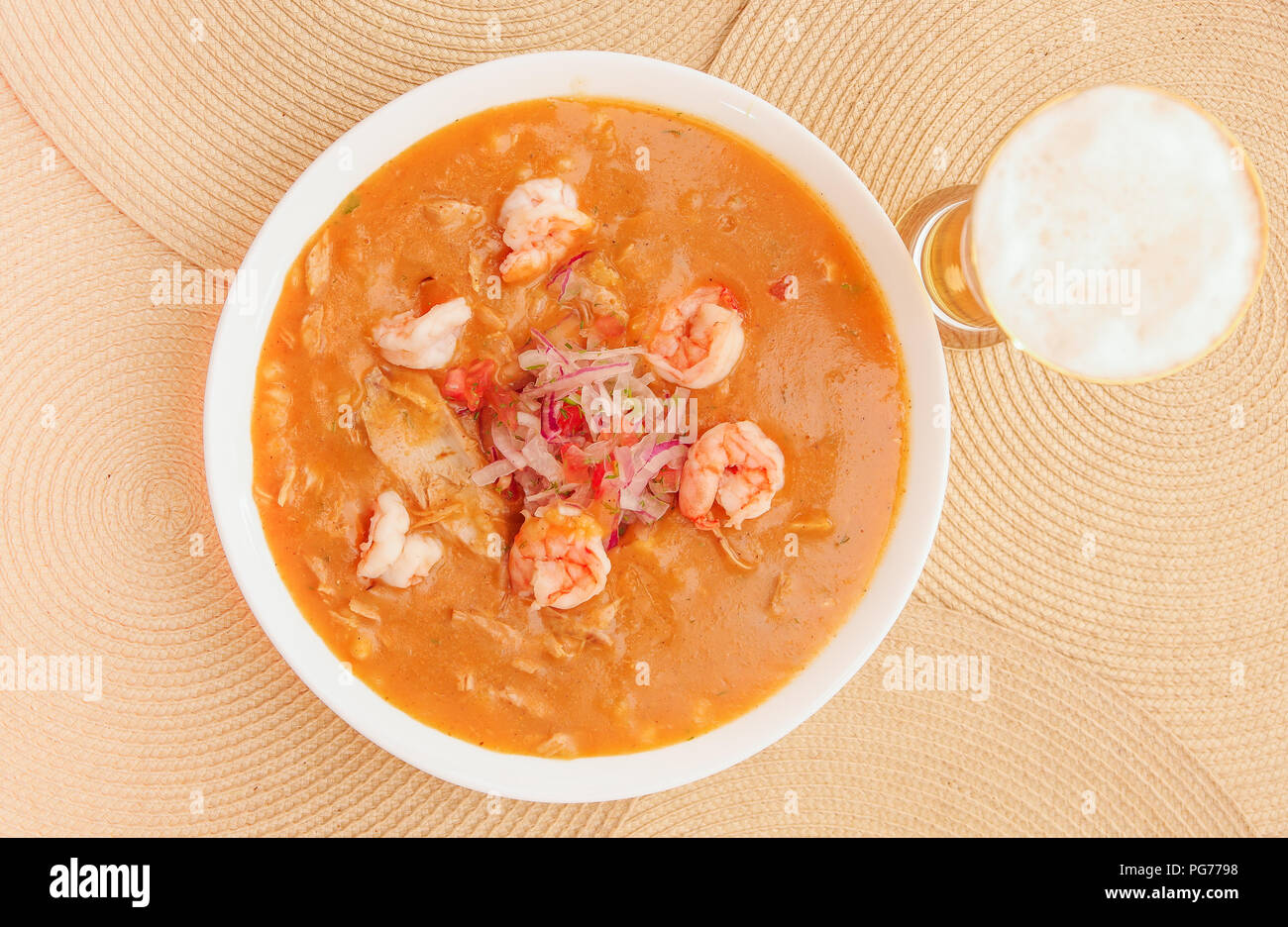 Above view of Ecuadorian food: shrimp cebiche with a glass of beer in wooden table background Stock Photo