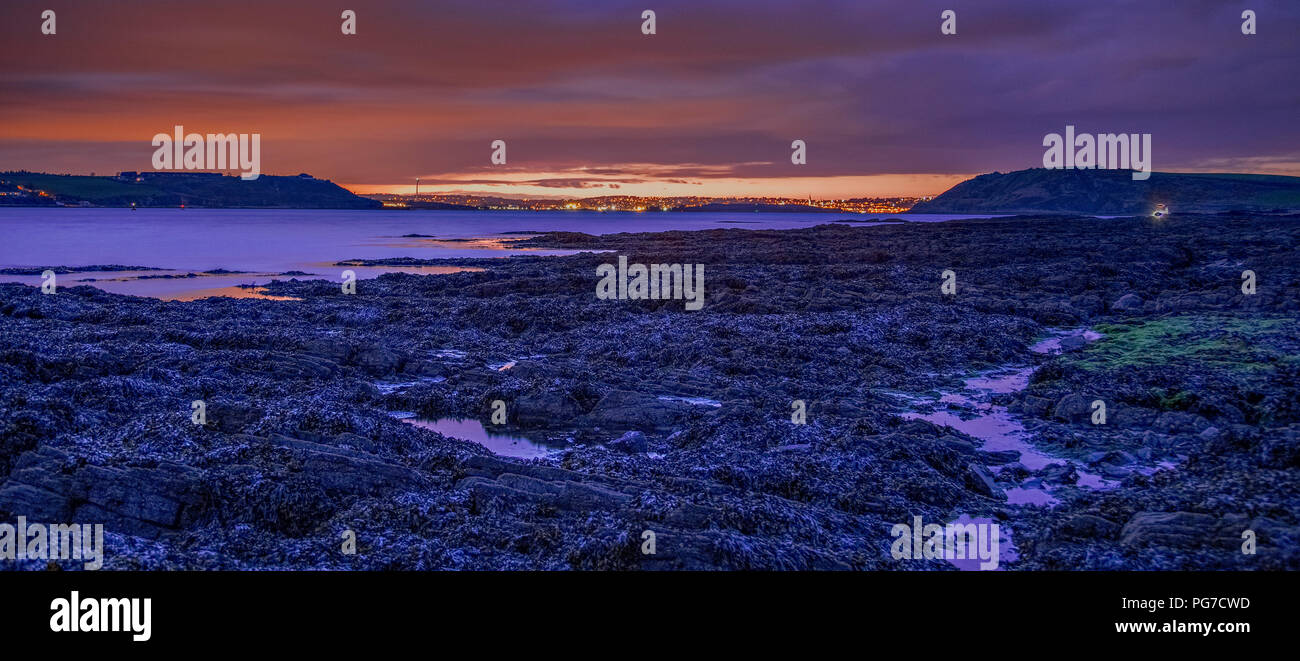 Cork at night as seen from Roaches Point at low tide on the south coast of Ireland Stock Photo