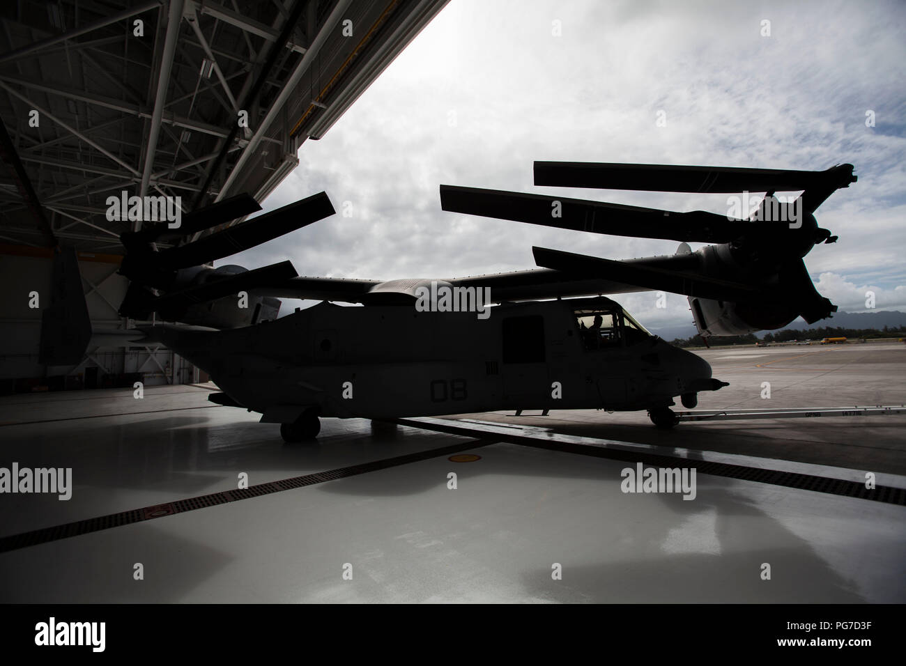 U.S. Marines park an MV-22 Osprey aircraft inside Hangar 7 prior to Hurricane Lane’s arrival at Marine Corps Air Station (MCAS) Kaneohe Bay, Marine Corps Base Hawaii (MCBH), Aug. 22, 2018. For safety and protection of assets, U.S. Marines conduct hurricane preparations aboard the installation. (U.S. Marine Corps photo by Sgt. Jesus Sepulveda Torres) Stock Photo