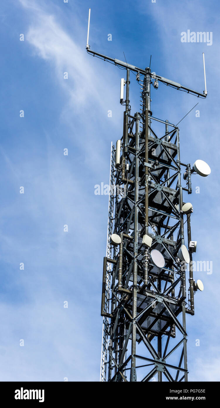 Antenna mast with many satellite shots, parabolants and directional antennas for listening, transmitting and monitoring. Stock Photo