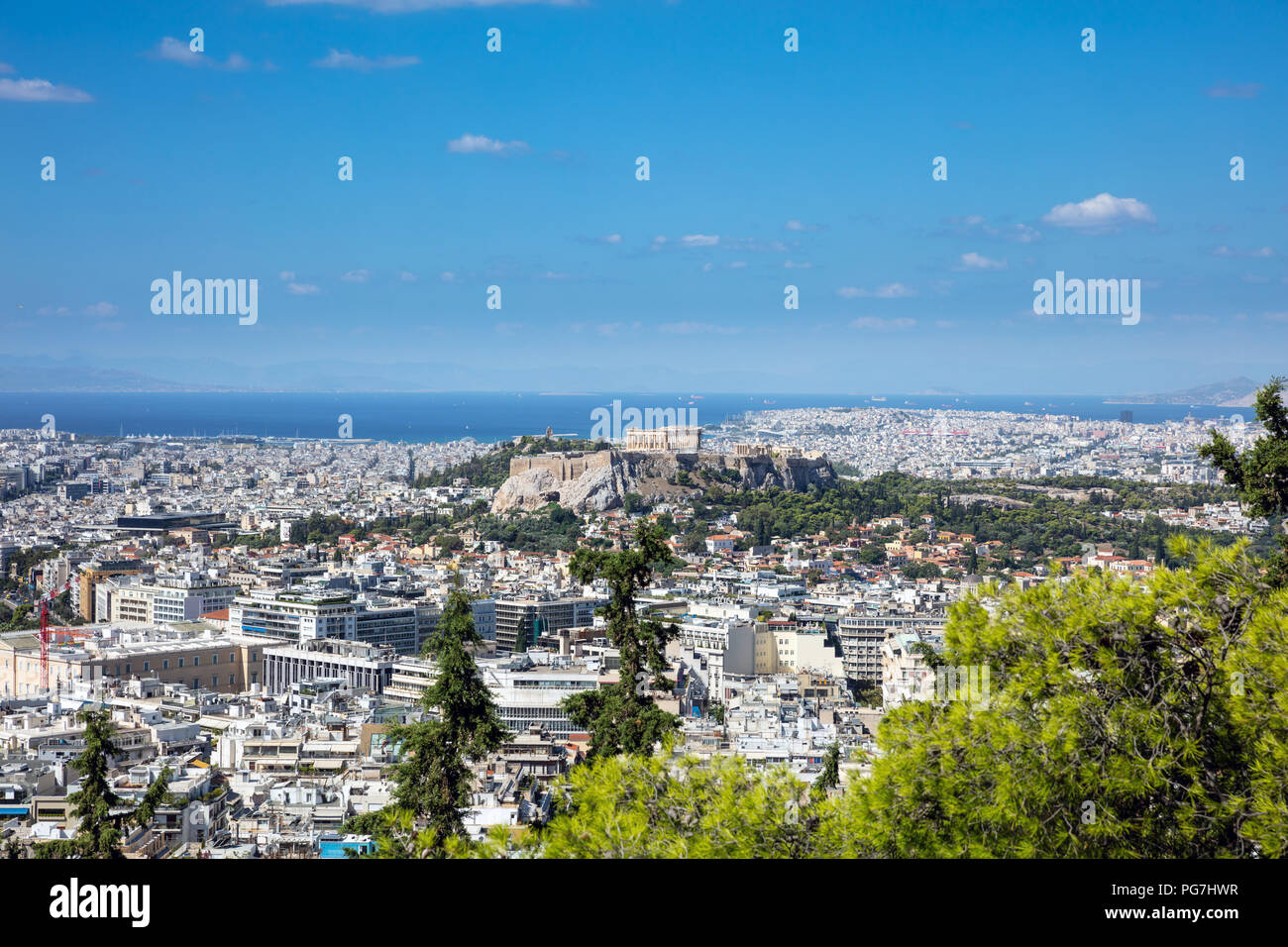 Panoramic aerial view of Acropolis of the city of Athens  in Greece with pine tree in the foreground, view from Lycabettus hill Stock Photo