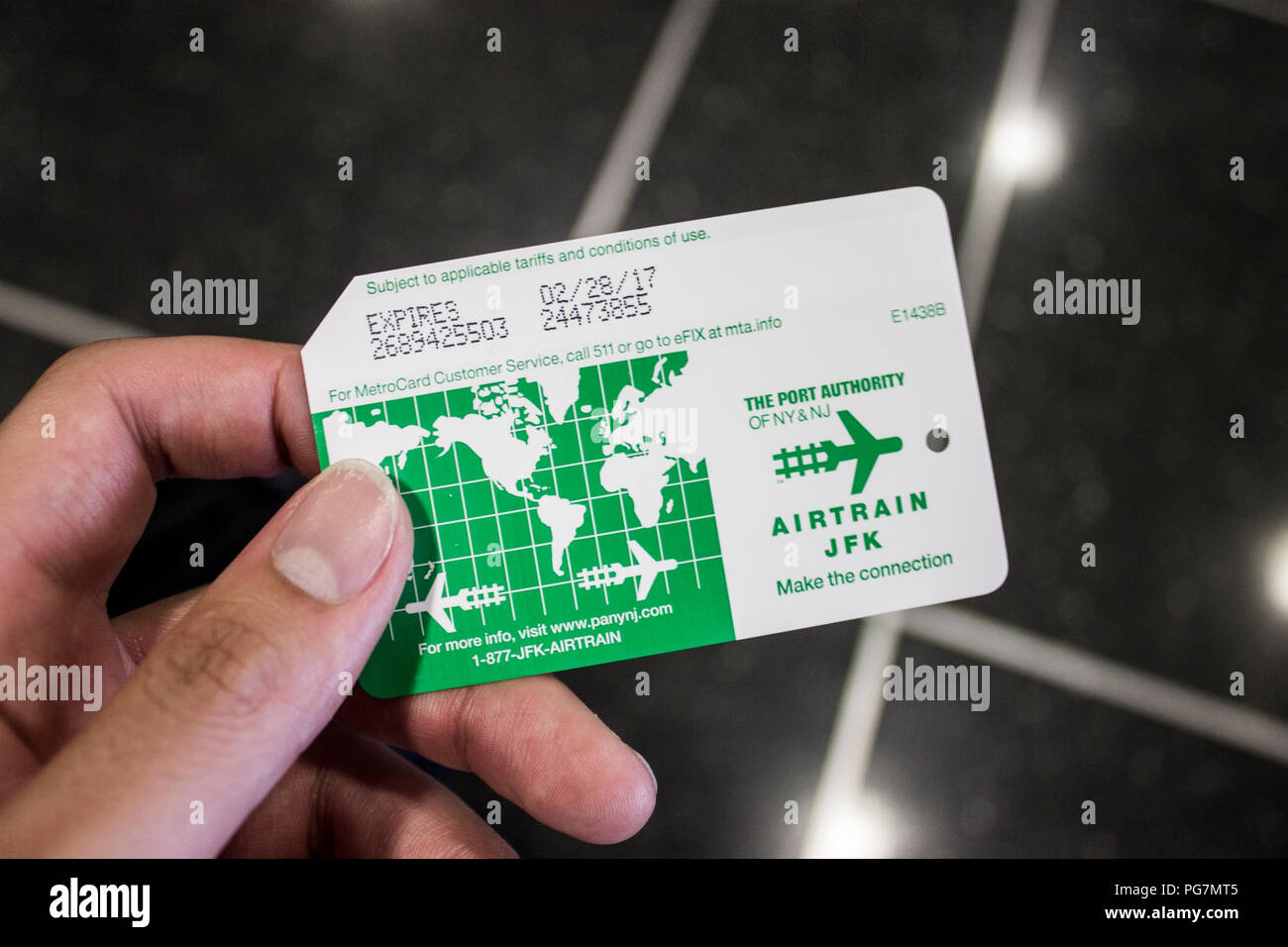 New York City. Hand holding an Airtrain metro ticket card for JFK