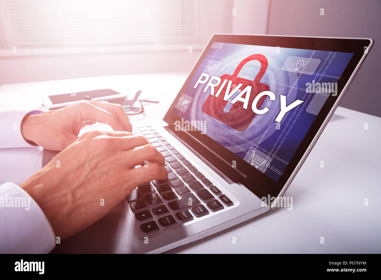 Close-up Of A Businessman's Hand Configuring Privacy Settings In A Laptop Stock Photo