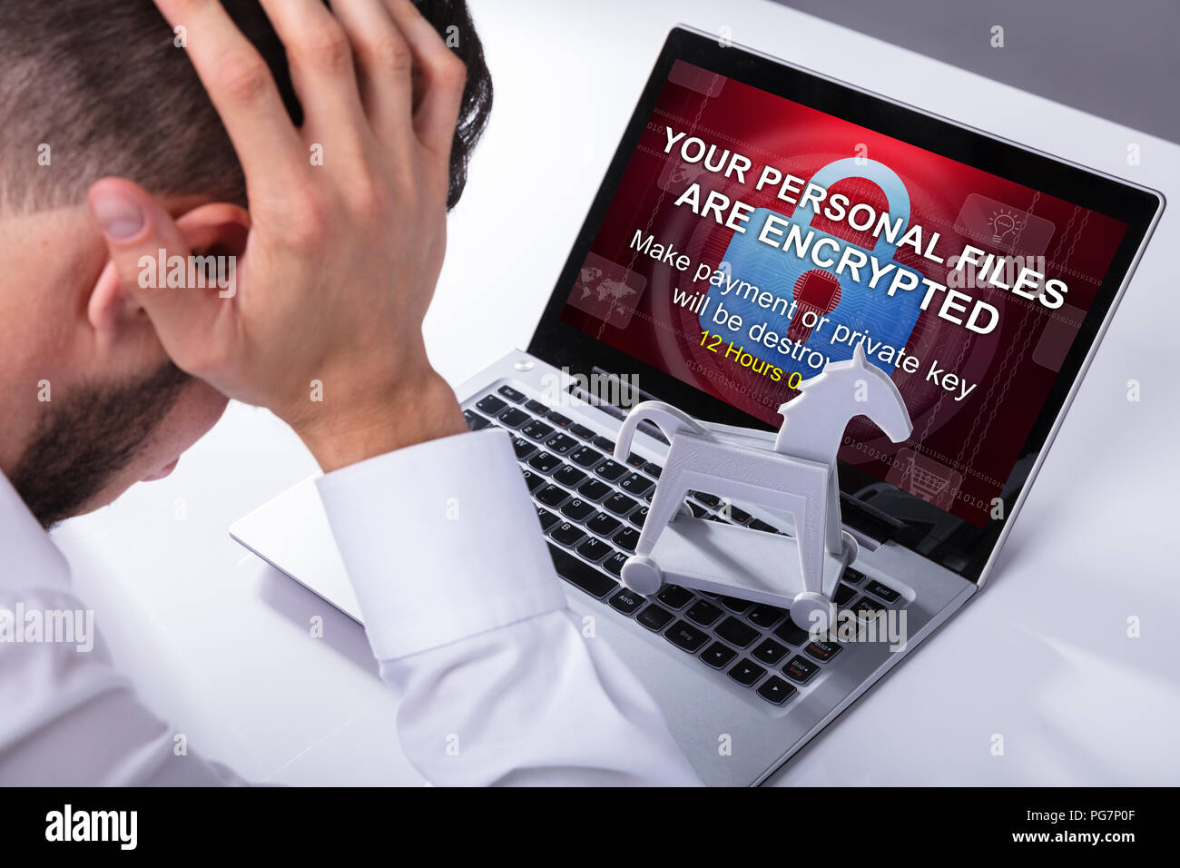 Close-up Of A Sad Businessman With Laptop Screen Showing Personal Files Encrypted Text Stock Photo