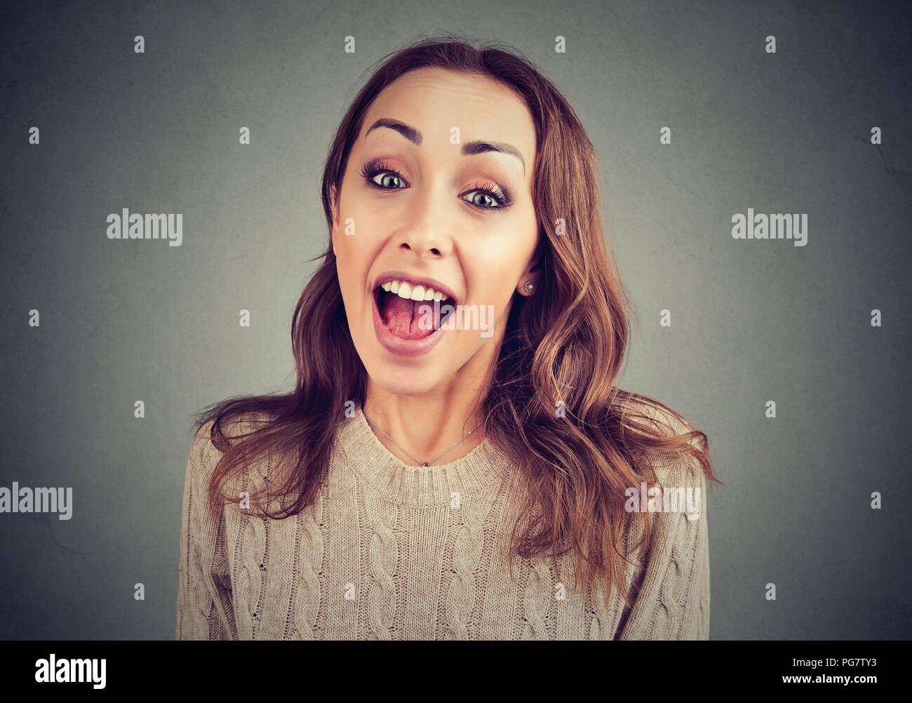 Young surprised funny looking woman in casual outfit excited with