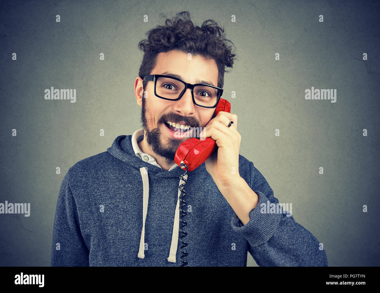 young happy man talking on a telephone Stock Photo