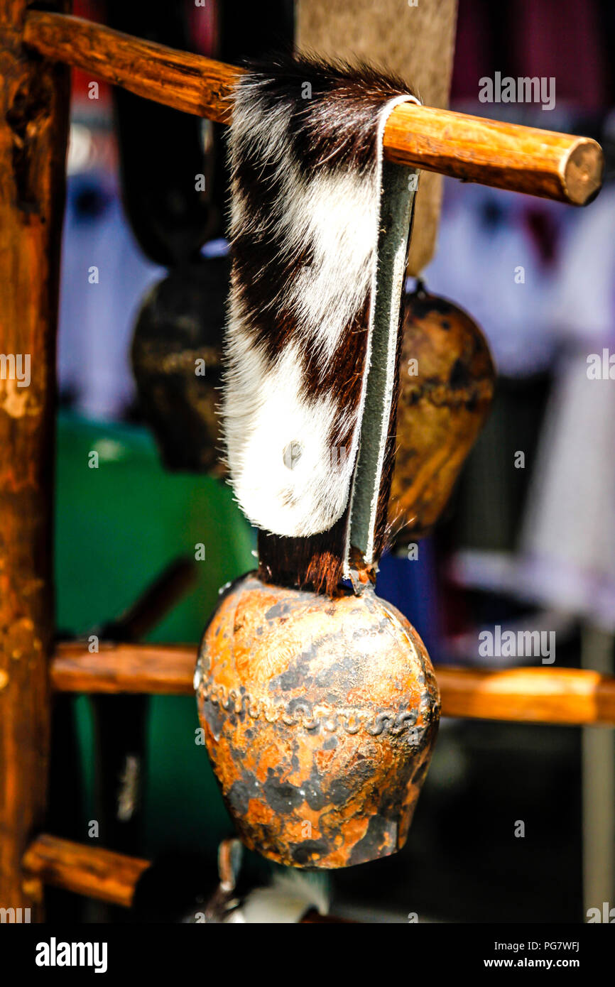 A Cowbell Hangs From A Cowhide Strap Outside A Store Selling